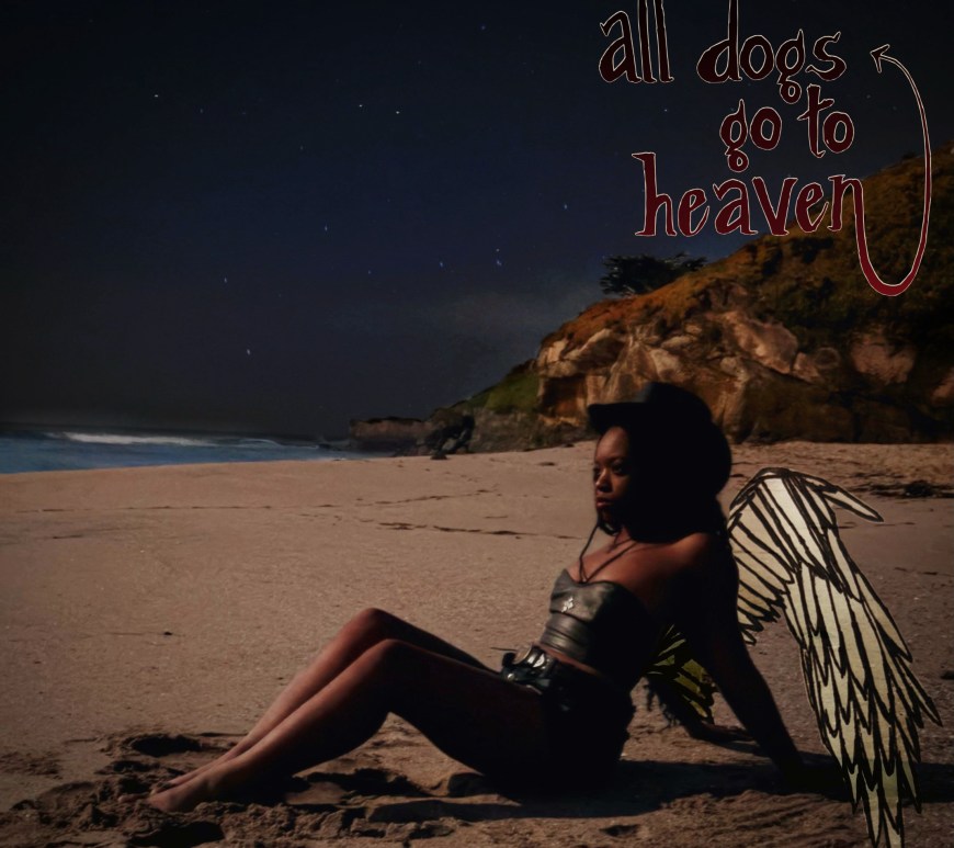 Aubrie sitting on the beach with wings